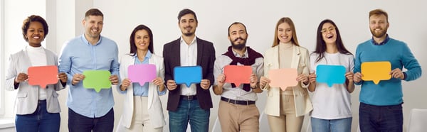 line of diverse people holding colorful 