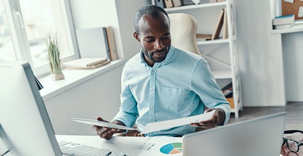 seated worker reviewing details of project