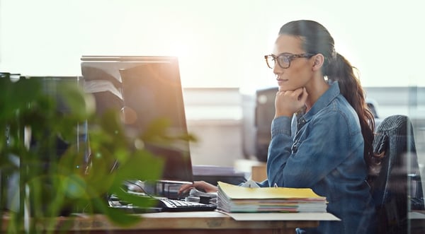 Female worker intently working at her desk